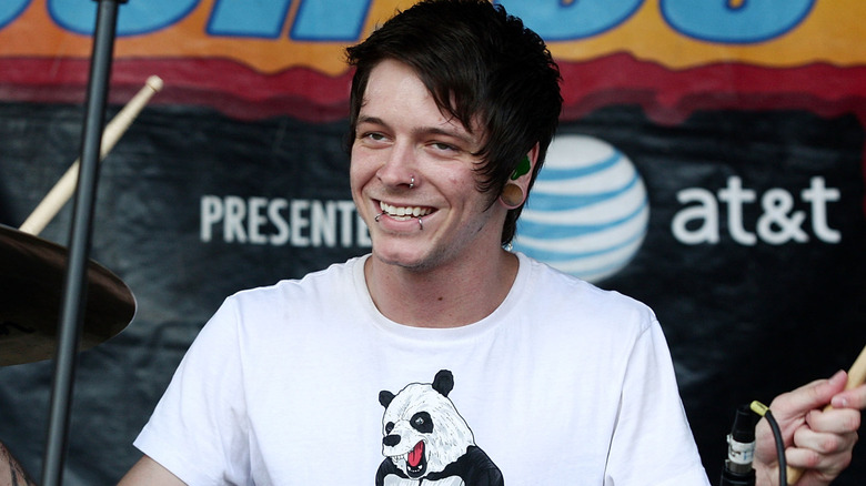 Daniel Williams smiles behind drums during Devil Wears Prada show