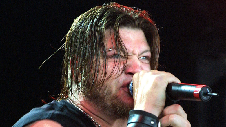 Dave Williams singing on stage with Drowning Pool