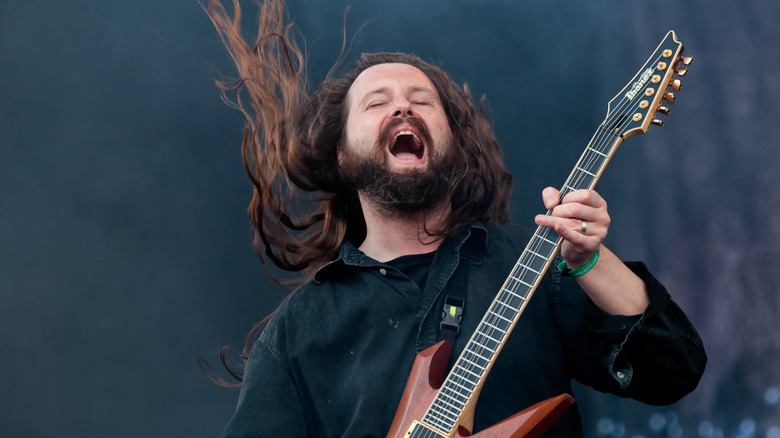 Oli Hebert playing guitar on stage with mouth agape