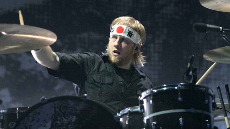 Bob Bryar playing drums wearing headband