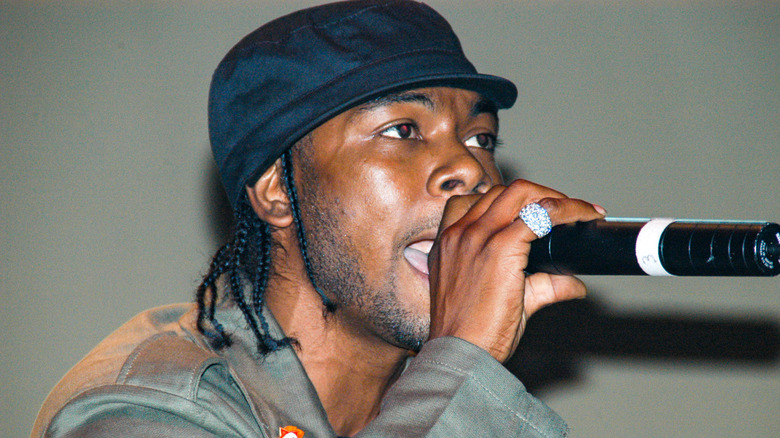 Static Major in hat rapping into microphone