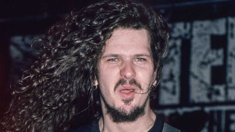 Dimebag Darrell Abbott playing guitar and sneering at camera