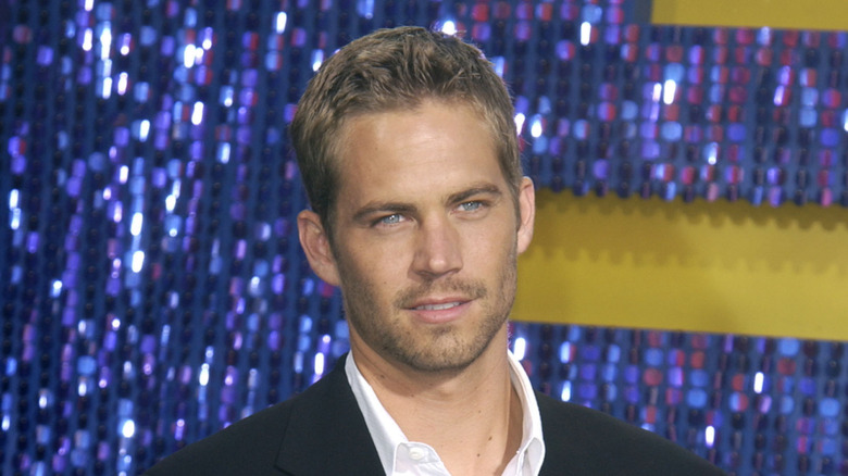 Paul Walker looking away smiling slightly