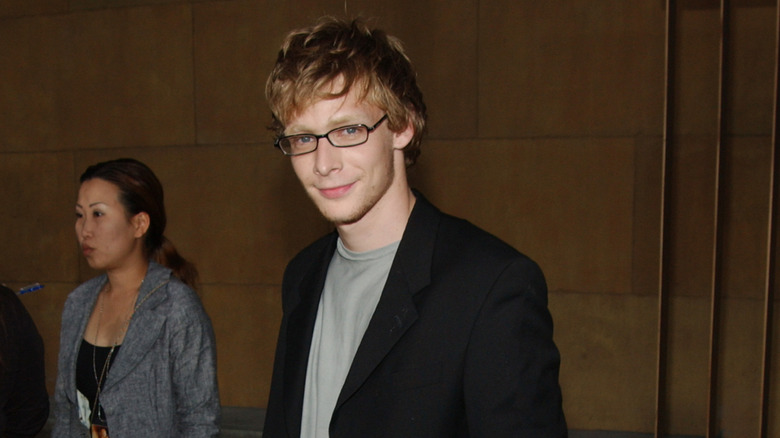 Johnny Lewis grinning askance at camera
