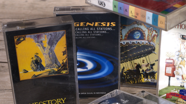 A collection of old cassette tapes, including Genesis' Calling All Stations