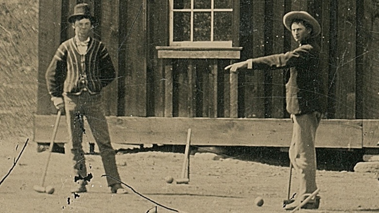 Billy The Kid standing outside