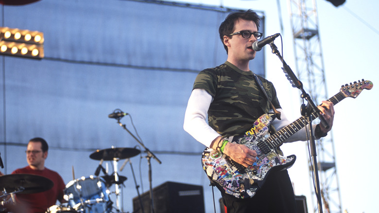 Rivers Cuomo playing colorful guitar