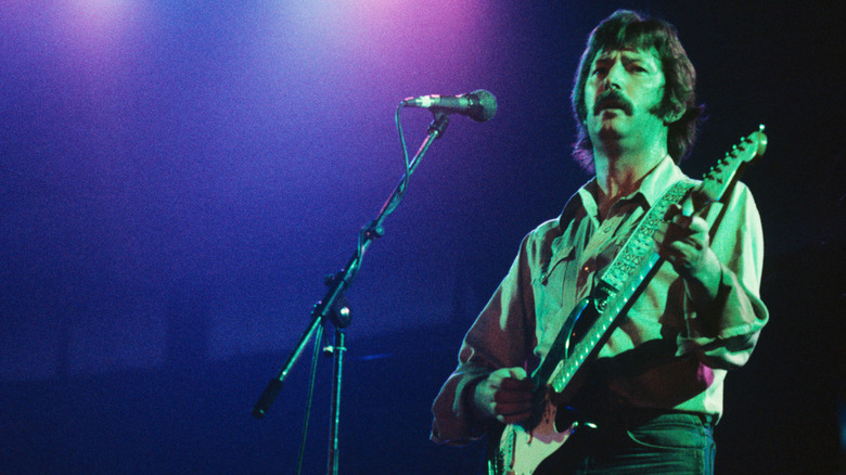 Eric Clapton playing guitar on stage