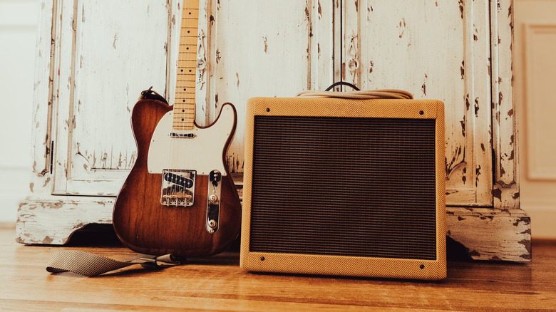 A guitar amp beside a guitar