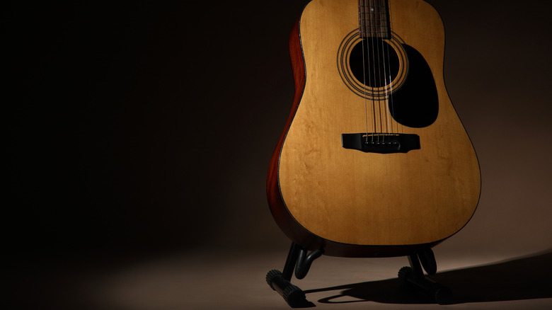 An acoustic guitar on a stand