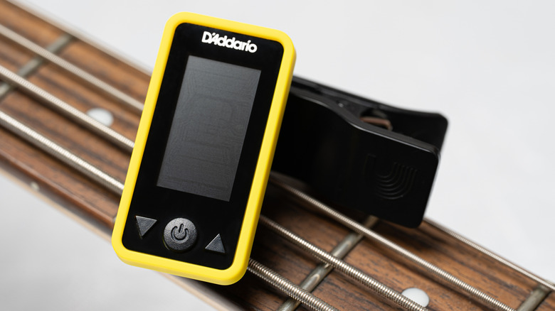 A tuner on an acoustic guitar