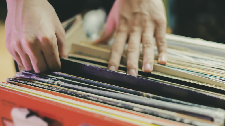 Person looking through record on shelves