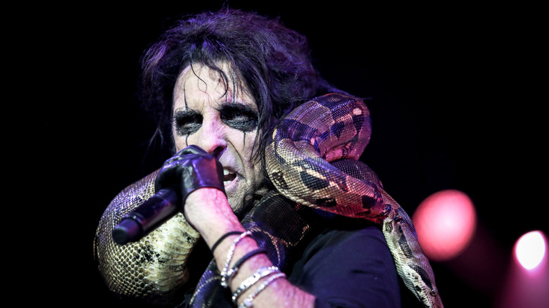 Alice Cooper with a snake wrapped around his neck