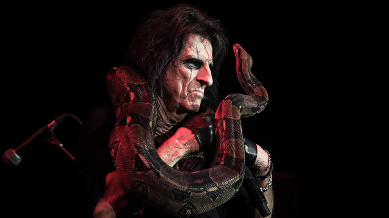 Alice Cooper with snake around his neck on stage