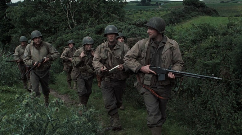 Cast members walking through French countryside in Saving Private Ryan