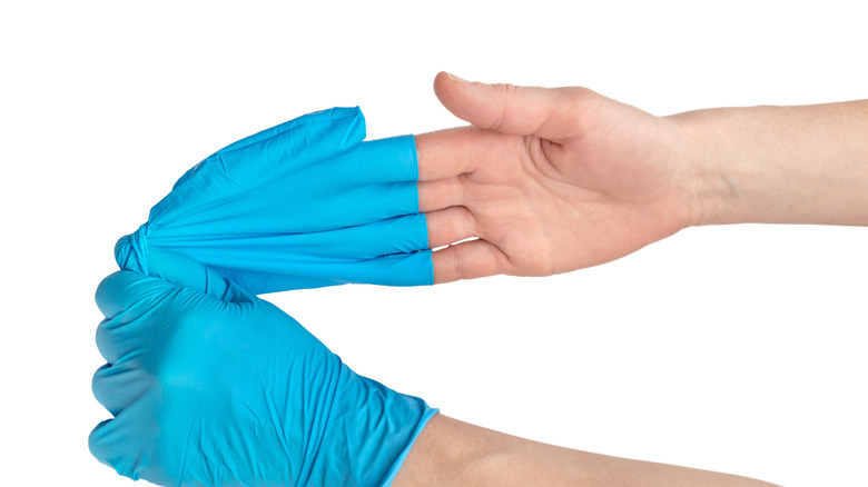 Person removing surgical gloves