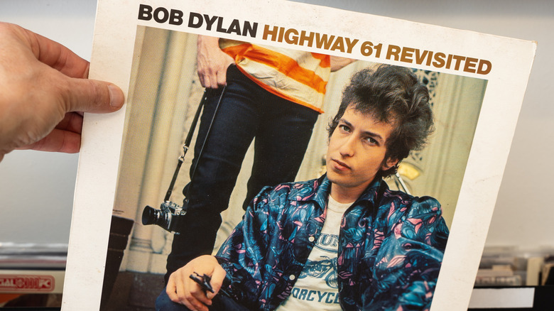Person pulling Bob Dylan out of box