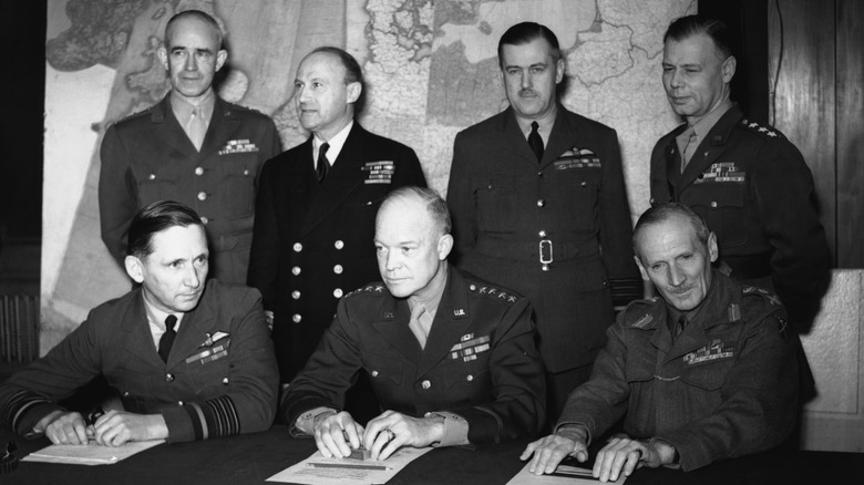 General Eisenhower with other US and UK generals in front of a map