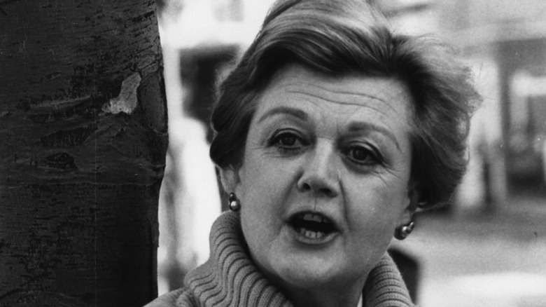 Angela Lansbury talks by a tree