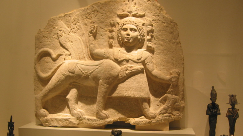 Tutu, Ammut, and the Seven Arrows relief in a museum
