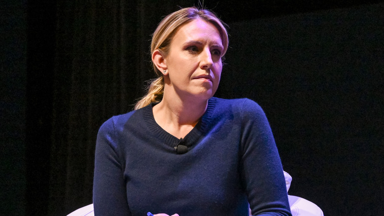 Poppy Harlow wearing a lapel mic on stage