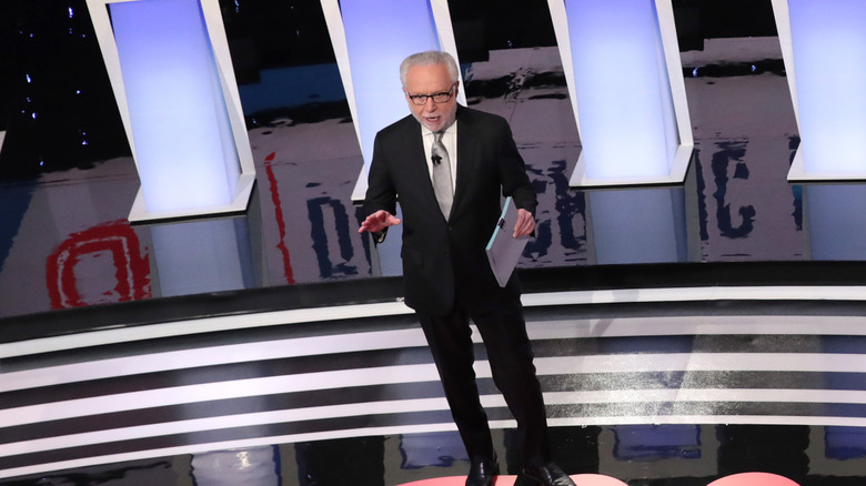 Poppy Harlow wearing a lapel mic on stage