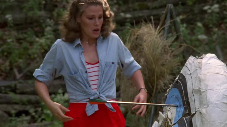 woman startled by an arrow hitting a target near her