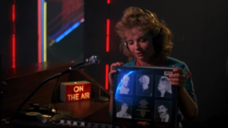 screenshot of blonde teenage girl seated in radio station