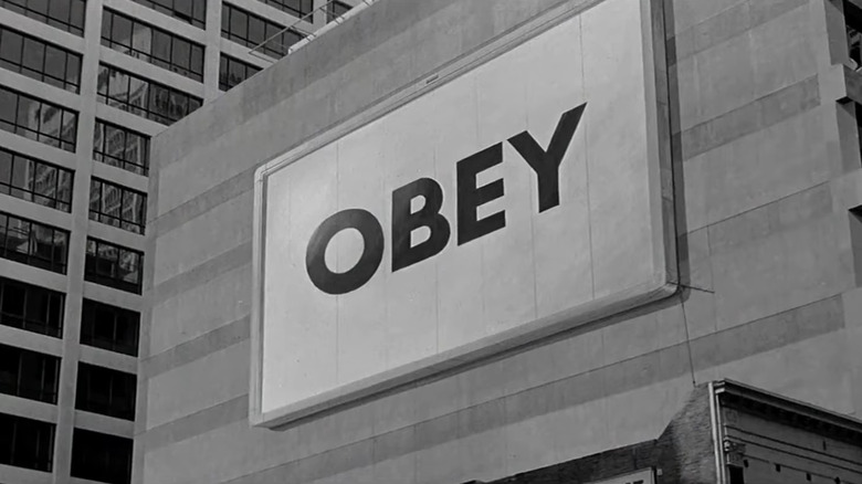 screenshot of billboard from movie reading "obey"