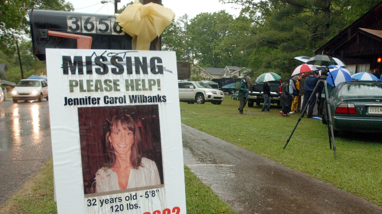 Sign calling for help finding Jennifer Wilbanks, 2005, people in background