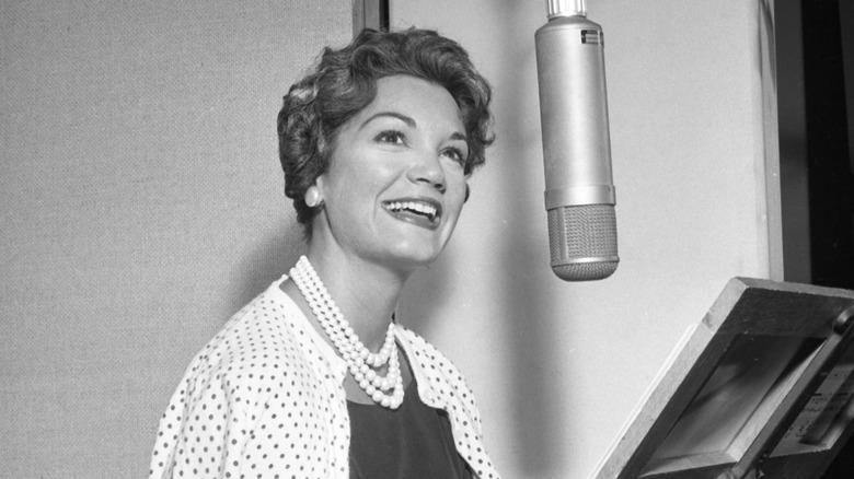 Connie Francis smiling in recording studio by mic