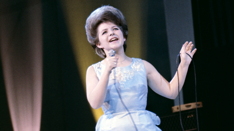 Brenda Lee singing in light blue dress on stage