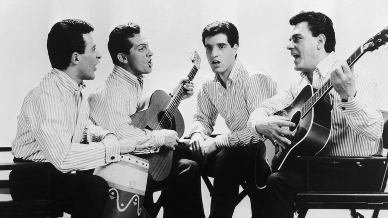 Four Seasons singing and playing guitars in publicity photo