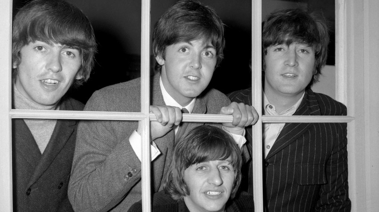 The Beatles peering through window