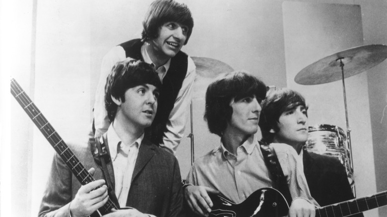 The Beatles in the 1960s posing with instruments