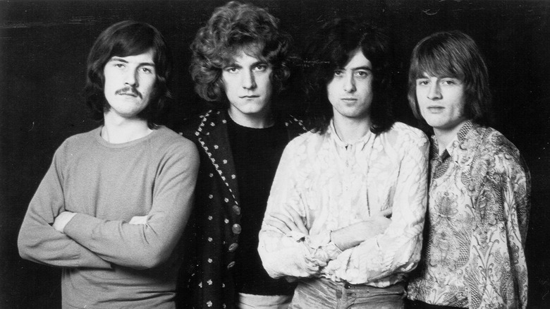 Led Zeppelin posing for a black and white group portrait