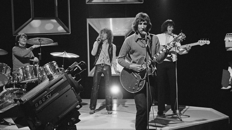 Black and white photo of the Who performing on a TV set