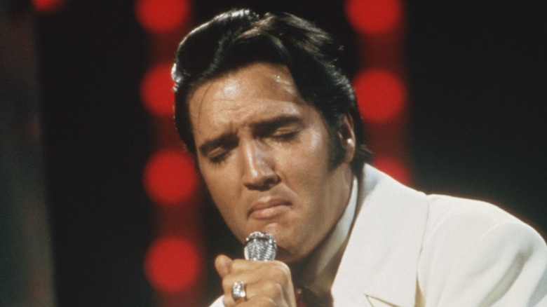 Elvis Presley singing on TV with eyes closed