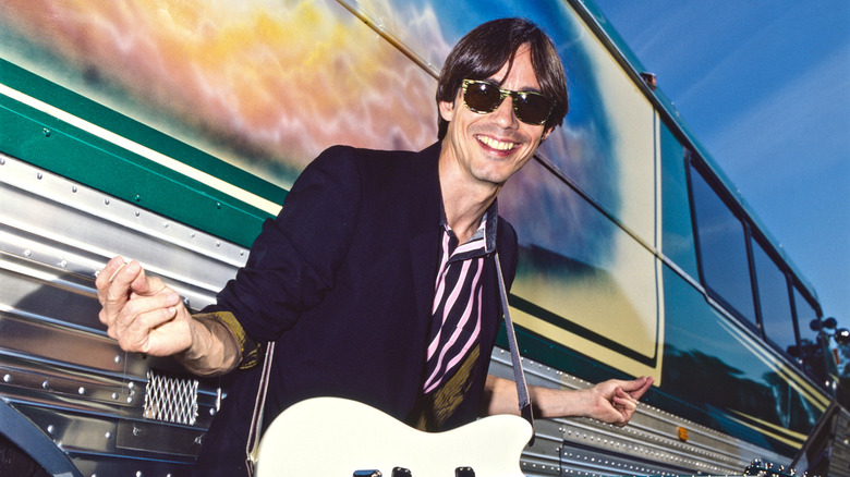 Jackson Browne posing in front of tour bus