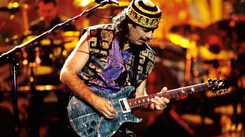 Carlos Santana playing guitar onstage in 1997
