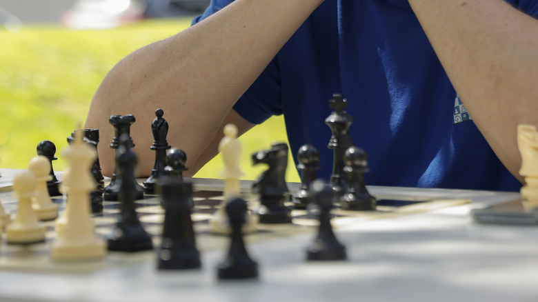 A chess player and board