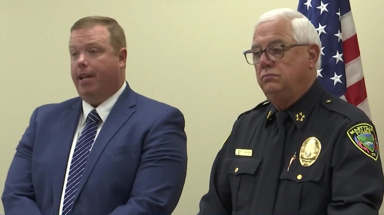 DIstrict attorney and police chief speaking at press conference on Fine murders