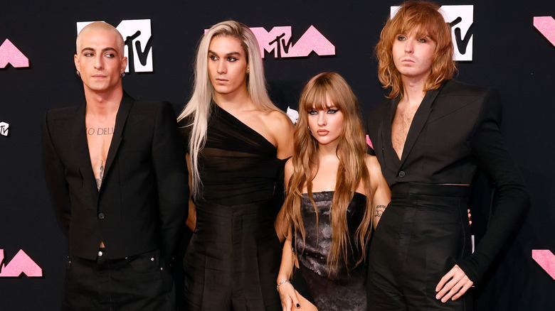 Maneskin posing against MTV backdrop