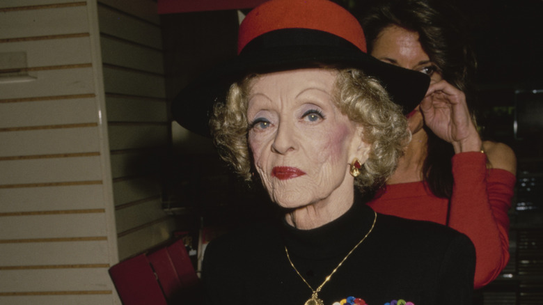 Bette Davis wearing a red hat