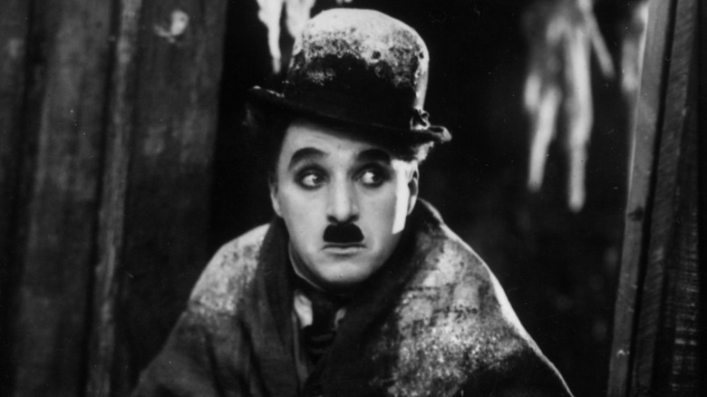 Charlie Chaplin in costume as the Little Tramp