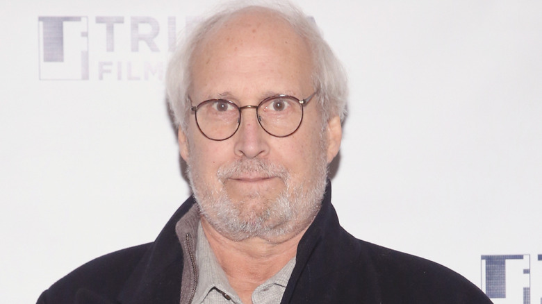 Chevy Chase in front of a white background at the Tribeca Film Festival