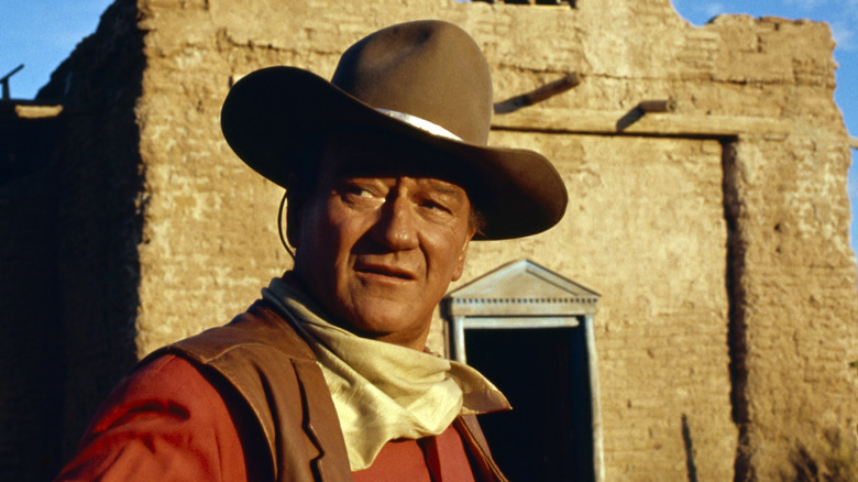 John Wayne in Western costume in front of the Alamo