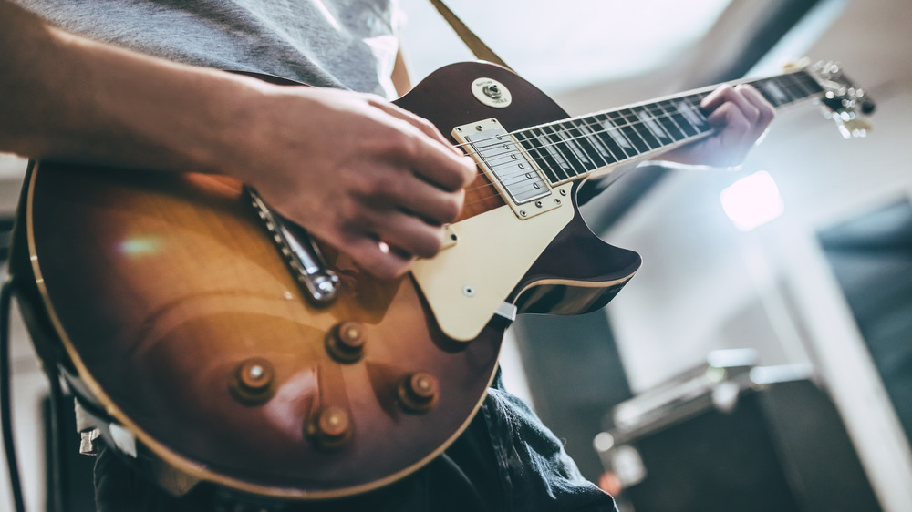 dude playing electric guitar