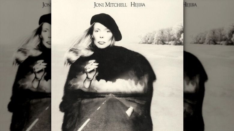 Cover art for Hejira by Joni Mitchell, depicting Mitchell with a picture of a road projected onto her silhouette