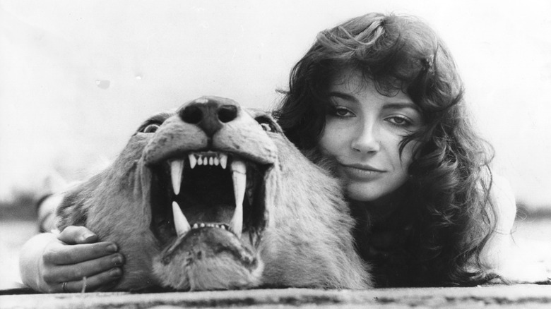 Kate Bush posing with lion skin rug